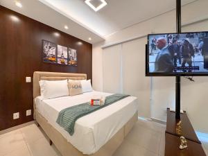 a bedroom with a bed and a flat screen tv at Condomínio Residencial Duo JK Sky - São José do Rio Preto in Sao Jose do Rio Preto +291 photos