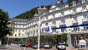 a large building with cars parked in front of it at FeWo"Augusta" in historischer Villa an der Emser Therme, kostenfreier Parkplatz in Bad Ems