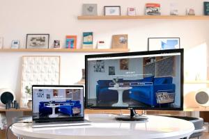 a desk with a laptop and a monitor on a table at OSTLOFT - Plattenbauappartement in Eisenhüttenstadt in Eisenhüttenstadt