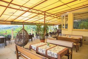 a restaurant with tables and chairs and a patio at Семеен хотел Балани in Gabrovo