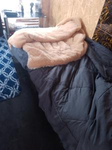 a blanket is laying on top of a bed at Bugambilia house in La Tinguiña +4 photos