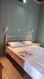 a bed with two towels on it in a bedroom at Villa Christina Sea Side A in Hanioti +11 photos