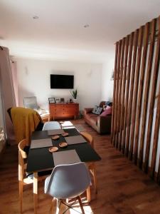 a living room with a table and a couch at Claires Cottage in Bethesda