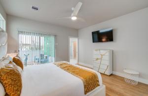 a bedroom with a bed and a tv on the wall at Luxe Family Stay Near NRG Game & Rodeo in Houston
