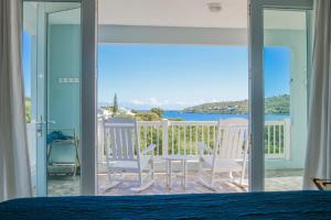 a bedroom with a bed and a view of the ocean at Island Charm Culebra - Studios & Suites - Amazing Water views in Culebra Puerto Rico! in Culebra