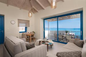 a living room with a view of the ocean at Astarte Villas Bleu Del Mar Villa in Argasi