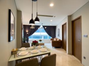 a dining room with a table and chairs at Vortex suites KLCC by Dela in Kuala Lumpur