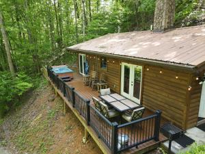 a log cabin with a deck in the woods at Smoky's Lodge in Pigeon Forge