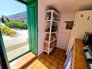 a room with a door open to a balcony at Small cozy house Susana in Mogán