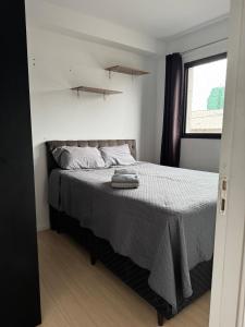 a bedroom with a bed with a gray blanket at 3-Apto Studio Liberdade 450' Metrô -Teatro Renault in Sao Paulo +67 photos