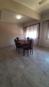 a dining room with a wooden table and chairs at Apartment for 4 people in Necochea +2 photos