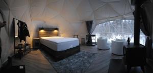 a bedroom with a bed in a tent at Glamping with the Stars, Aquarius in Hadashville