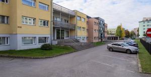 a car parked in a parking lot in front of buildings at Laine Apartment in Pärnu