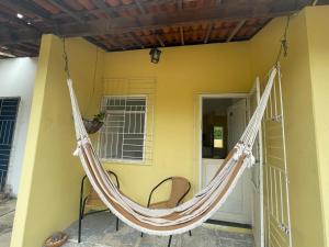 a hammock hanging on a porch of a house at Chalé Pitaya 05 in Piranhas +3 photos