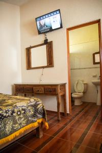 a bedroom with a bed and a mirror and a sink at Hotel Pueblo Viejo in Parras de la Fuente +41 photos