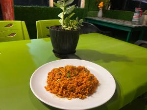 a plate of food on a green table with a plant at The Nirvana Stays in Nainital +55 photos