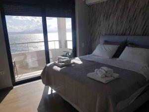 a bedroom with a bed with two towels on it at Premium Luxury Condo with breathtaking views in Loutraki
