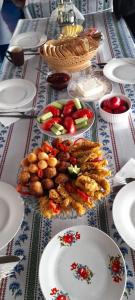 a table with plates of food on top of it at Pensiune Agroturistica CASA LETEA in Letea
