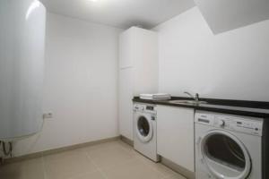 a washer and dryer in a white room at Crest 5 - 8 Pax Golf & Beach Swimming pool in Almancil