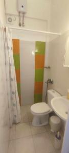 a bathroom with a toilet and a sink at Filina's Room 1 in Maltezana +15 photos