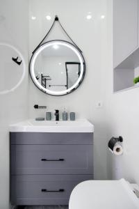 a bathroom with a sink and a mirror at Central Light Apartment in Almaty +34 photos