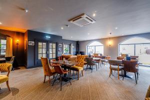a restaurant with tables and chairs in a room at Dotty's Sunshine Cottage in Reighton