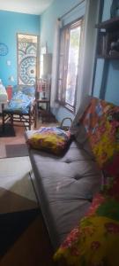 a couch with pillows on it in a living room at Chalé Puertas y Ventanas in São Sebastião +22 photos