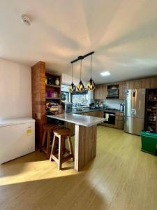a large kitchen with a large island in the middle at Finca Amatista in Guarne