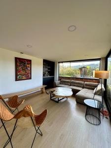a living room with a couch and a table and chairs at Finca Amatista in Guarne