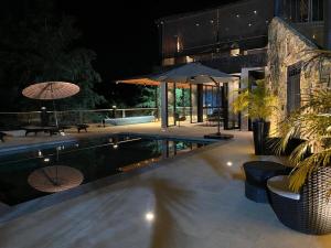 a house with a swimming pool at night at Finca Amatista in Guarne