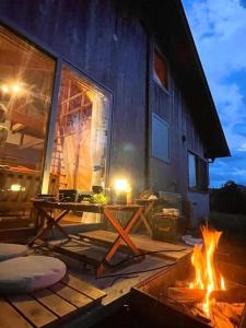 a fire pit in front of a house at night at Gubo Satoyama Suite Lodge & Camp - Vacation STAY 39509v in Katsuura