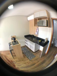 a small kitchen with a sink and a counter at Pousada Soares in Piçarras