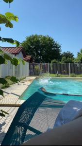 a swimming pool in a yard with a fence at La Jarria in Jurançon