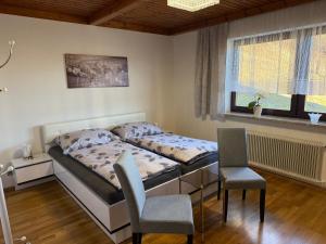 a bedroom with a bed and a table and chairs at Ferienhaus Ursula Velden in Velden am Wörthersee +34 photos