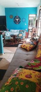 a living room with two pillows on a couch at Chalé Puertas y Ventanas in São Sebastião