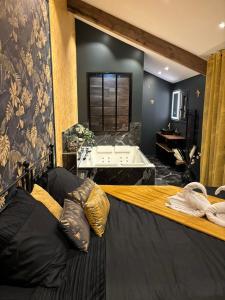 a bedroom with a bed and a table in a room at La cachette enchantée in Saint-Cyr-la-Campagne