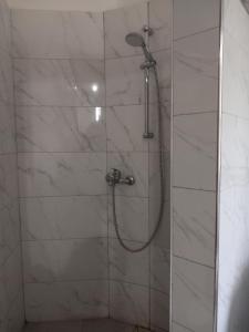 a bathroom with a shower with a glass door at 5 Bedroom Holiday Home in Kigo, off Entebbe Expressway in Kampala