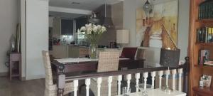 a living room with a table and a vase of flowers at Spacious House in Calafell with Shared Pool in Calafell