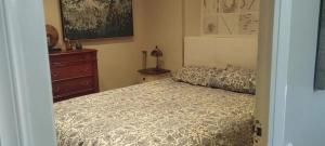 a bedroom with a bed and a dresser at Spacious House in Calafell with Shared Pool in Calafell +16 photos
