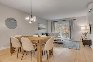 a dining room and living room with a table and chairs at Initial - Mountain 302 - Ski-in-out MSA in Beaupré