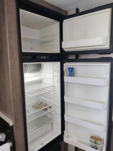 an empty refrigerator with its door open and its door at Beachfront Camper, Bahia Turquesa BCS in La Ventana +37 photos