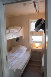 a small room with two bunk beds and a window at Alpinlandsbyen - Ski in - Ski out -Nr 34 in Hafjell