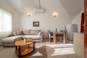 a living room with a couch and a table at Vladivostok Apartments in Tivat