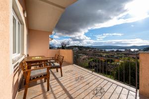 a balcony with a table and chairs and a view at Vladivostok Apartments in Tivat