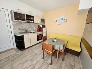 a kitchen and dining room with a table and chairs at Къща за гости Ани in Chernomorets