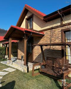 a brick house with a porch and a swing at Old Town in Çilǝgir