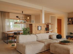 a living room with a couch and a table at Beach House on the Northen Shore of lake Peipus in Alajõe