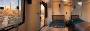 a room with two beds and a large window at Super Elite apartments & Studios - Aswan city center apartments in Aswan