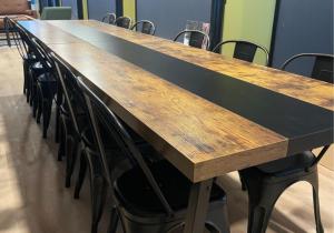 a long wooden table with chairs around it at Zenith Basecamp in Duluth