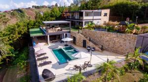 an aerial view of a house with a swimming pool at Finca Amatista in Guarne